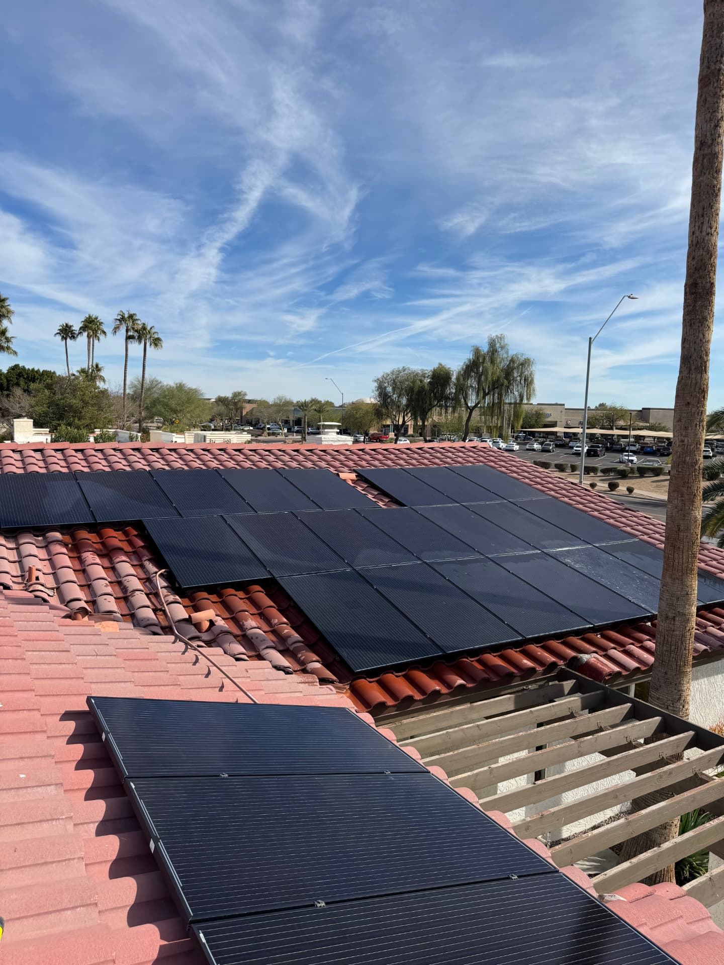 Clean solar panels on a red tile roof under a blue Arizona sky