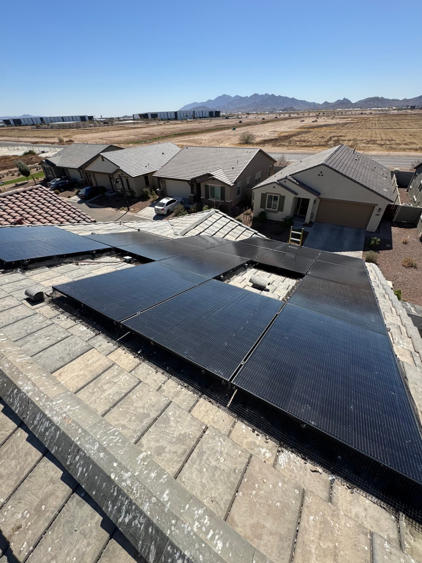 Freshly cleaned solar panels on a tile roof with mountain views