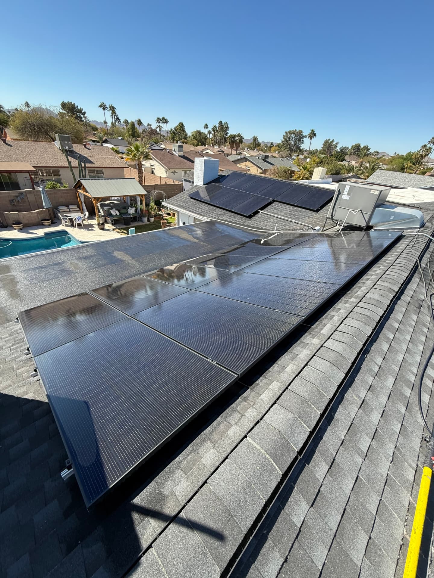 Sparkling solar array above a backyard pool after cleaning