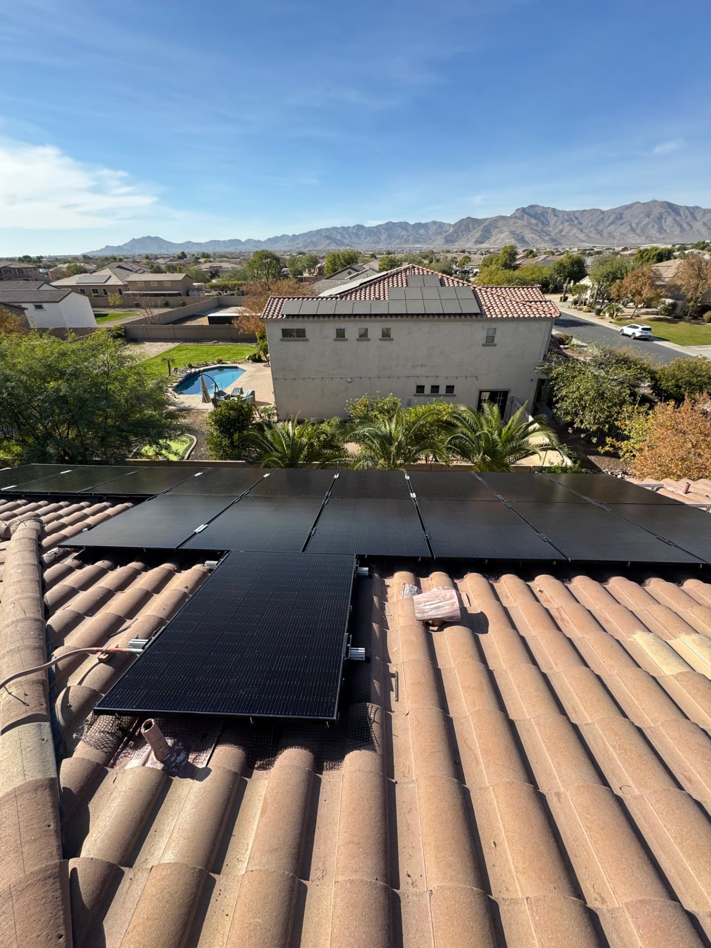 Cleaned solar panels on a tile roof with mountain views